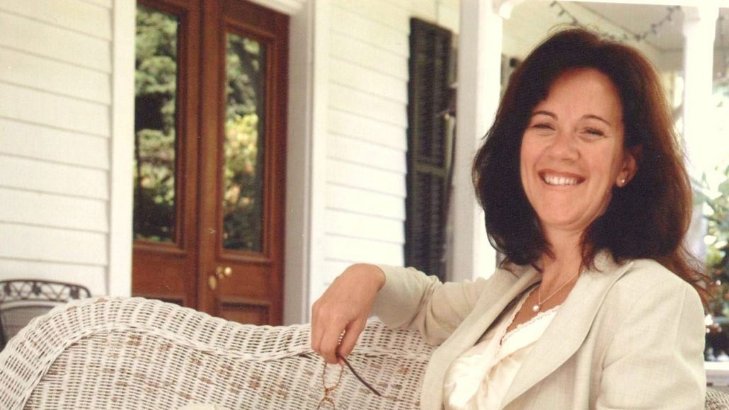 Patricia sitting on chair outside of house